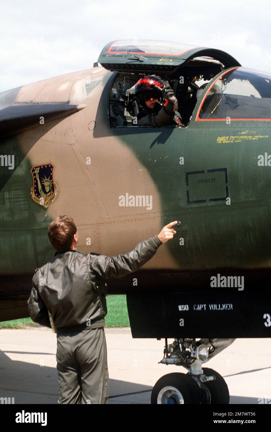 A British Royal Air Force pilot, aboard an F111 aircraft, stops to