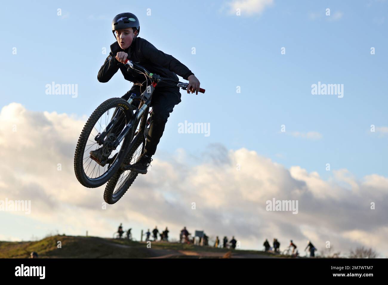 People jump their mountain bikes at a BMX and pump track in Fleet