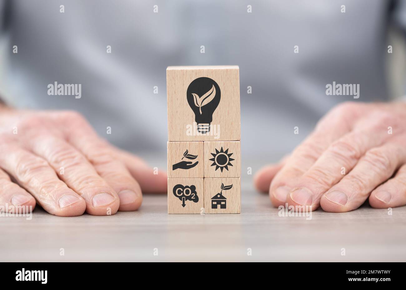 Wooden blocks with symbol of green energy concept Stock Photo - Alamy
