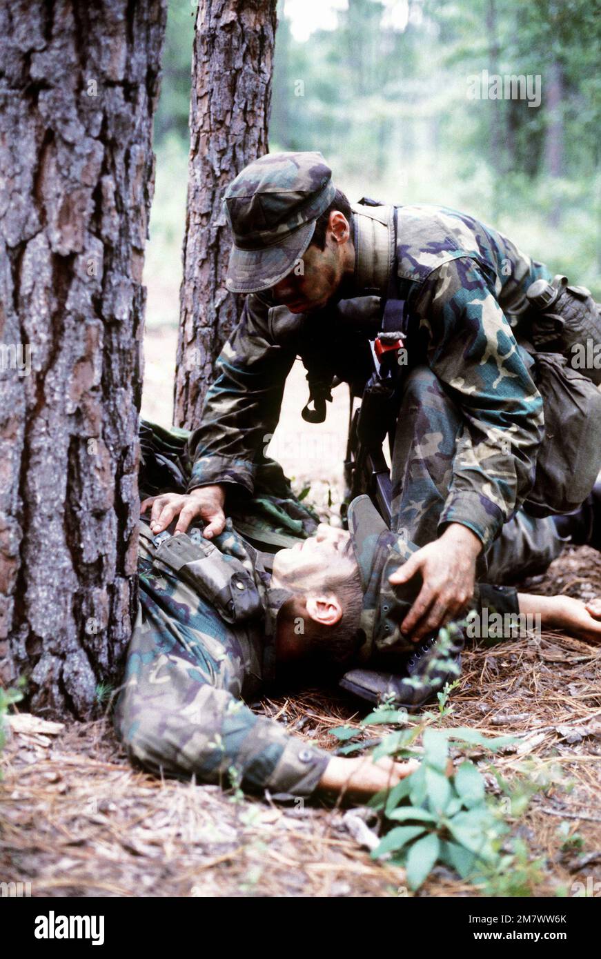 A Combat Control School student prepares a 'wounded-soldier'. The students are participating in first aid training before becoming Red Berets upon their graduation. Base: Pope Air Force Base State: North Carolina (NC) Country: United States Of America (USA) Stock Photo