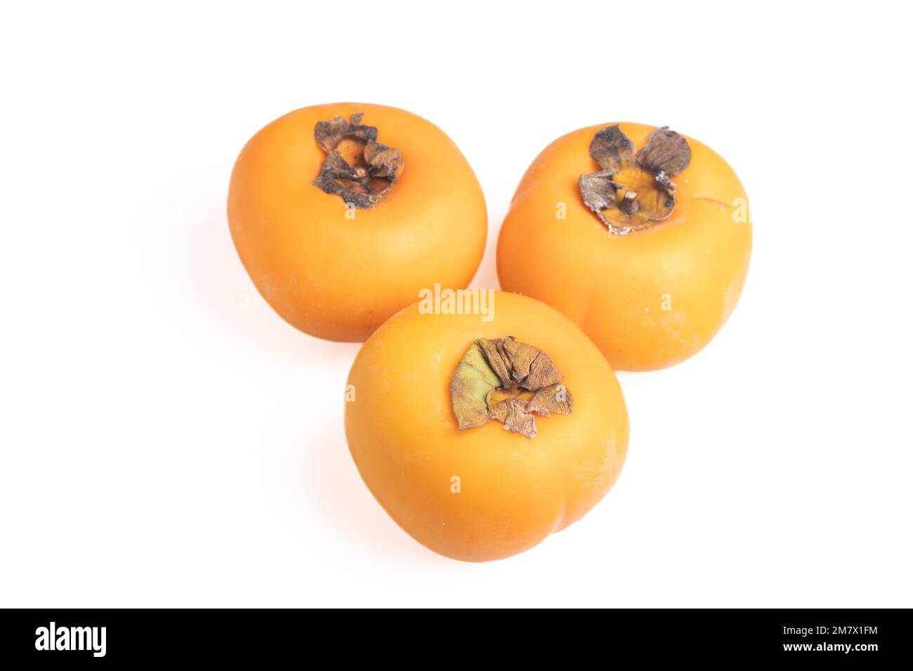fresh persimmons on a white background Stock Photo