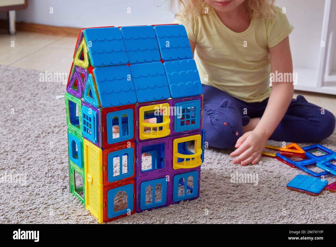 house made magnetic constructor. Faceless child background building house constructor Stock Photo