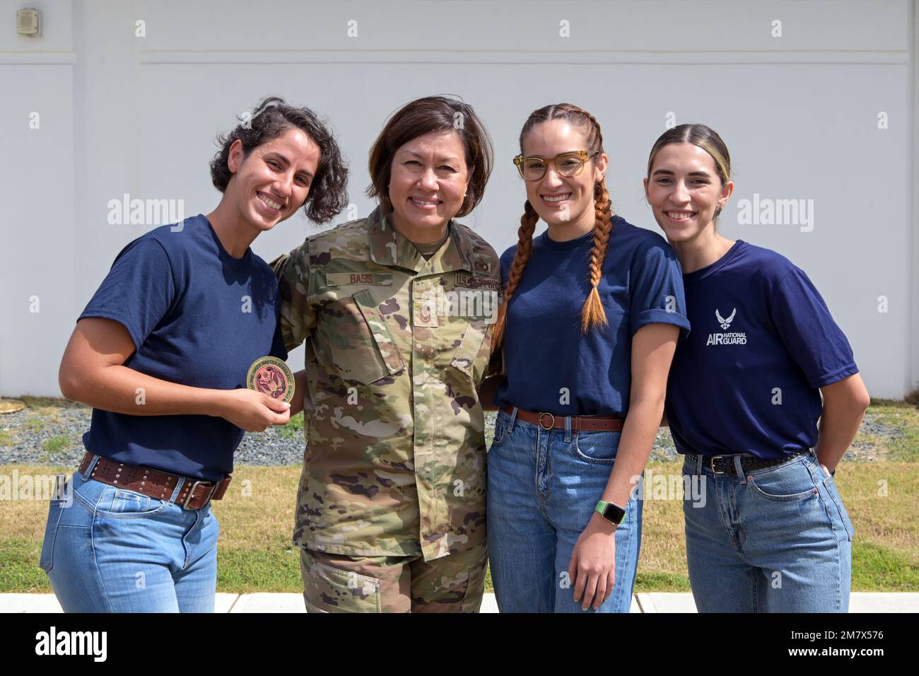 Chief Master Sgt. of the Air Force JoAnne S. Bass, pause for a group photo with Airmen from the 156th Wing public affairs office at Muñiz Air National Guard Base, Carolina, Puerto Rico, May 14, 2022. CMSAF Bass engaged with Airmen during her visit to the 156th Wing and emphasized the importance of total force integration and overcoming challenges to more effectively accomplish the Air Force mission and be ready for the ever-evolving battlefield that future conflicts may hold. Stock Photo