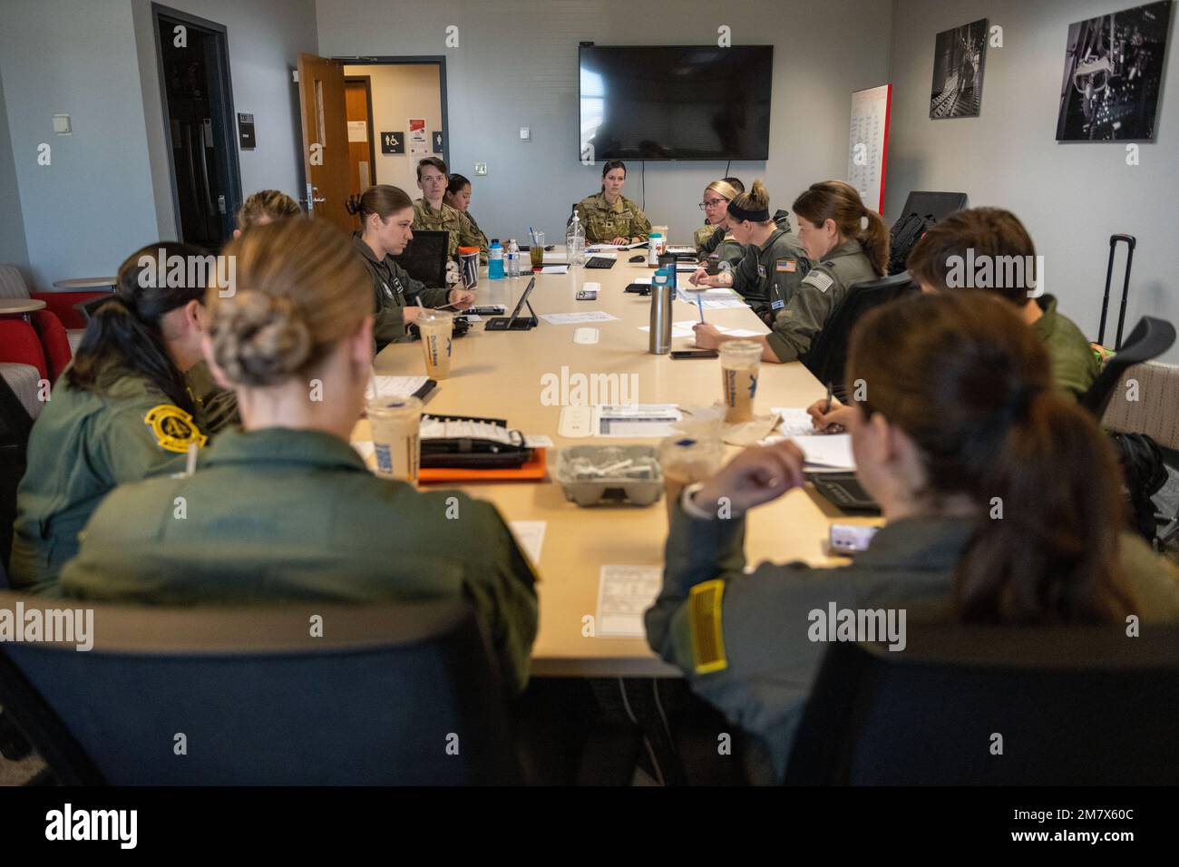 U.S. Air Force aircrew members go over mission planning prior to performing in the Parade of Heavies for the Wings Over Solano open house and air show at Travis Air Force Base, California, May 14, 2022. The two-day event also featured performances by the Wings of Blue parachute team and F-16 and F-35 Demo Teams and static displays. Stock Photo