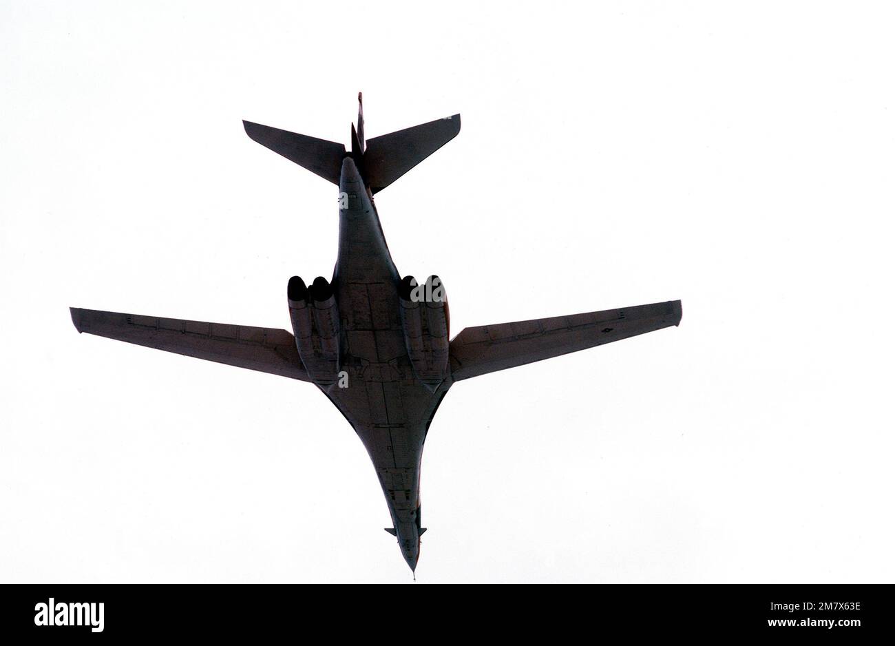 An underside view of a B-1 bomber aircraft on its first flight since