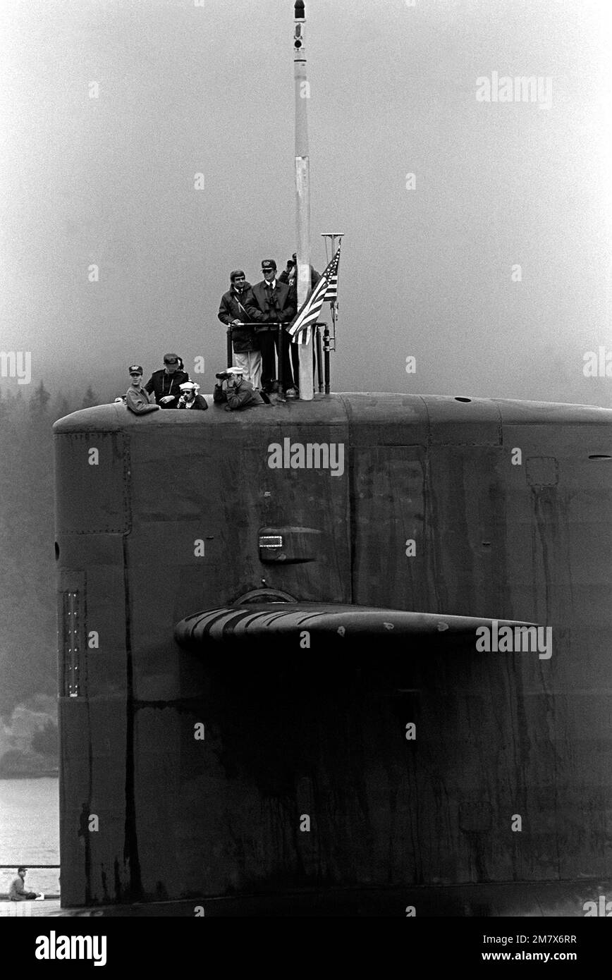 A port side view of crewmen on the sail of the nuclearpowered