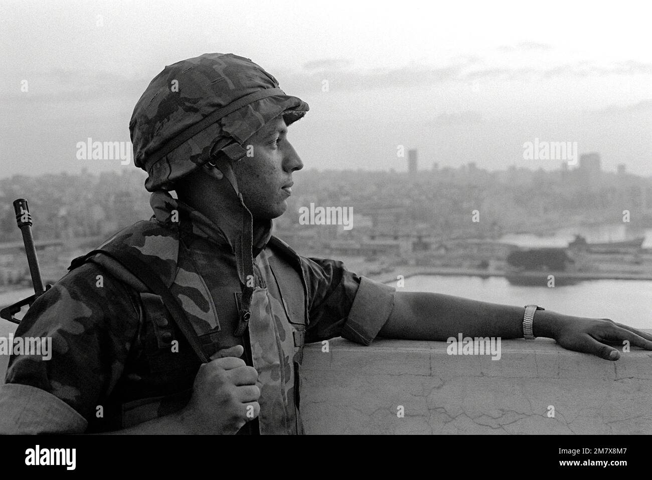 A U.S. Marine of the 32nd Marine Amphibious Unit stands guard from a position overlooking the city after the Marine contingent of the multi-national peace-keeping force assume management of the port of Beirut. Base: Beirut Country: Lebanon (LBN) Stock Photo