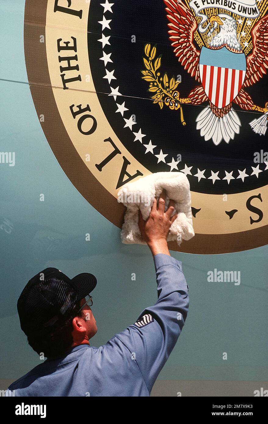 MASTER SGT. Robert Klingelsmith, 89th Airlift Wing, polishes the presidential seal on Air Force One, A VC-135B Stratoliner aircraft. Base: Andrews Air Force Base State: Maryland (MD) Country: United States Of America (USA) Stock Photo