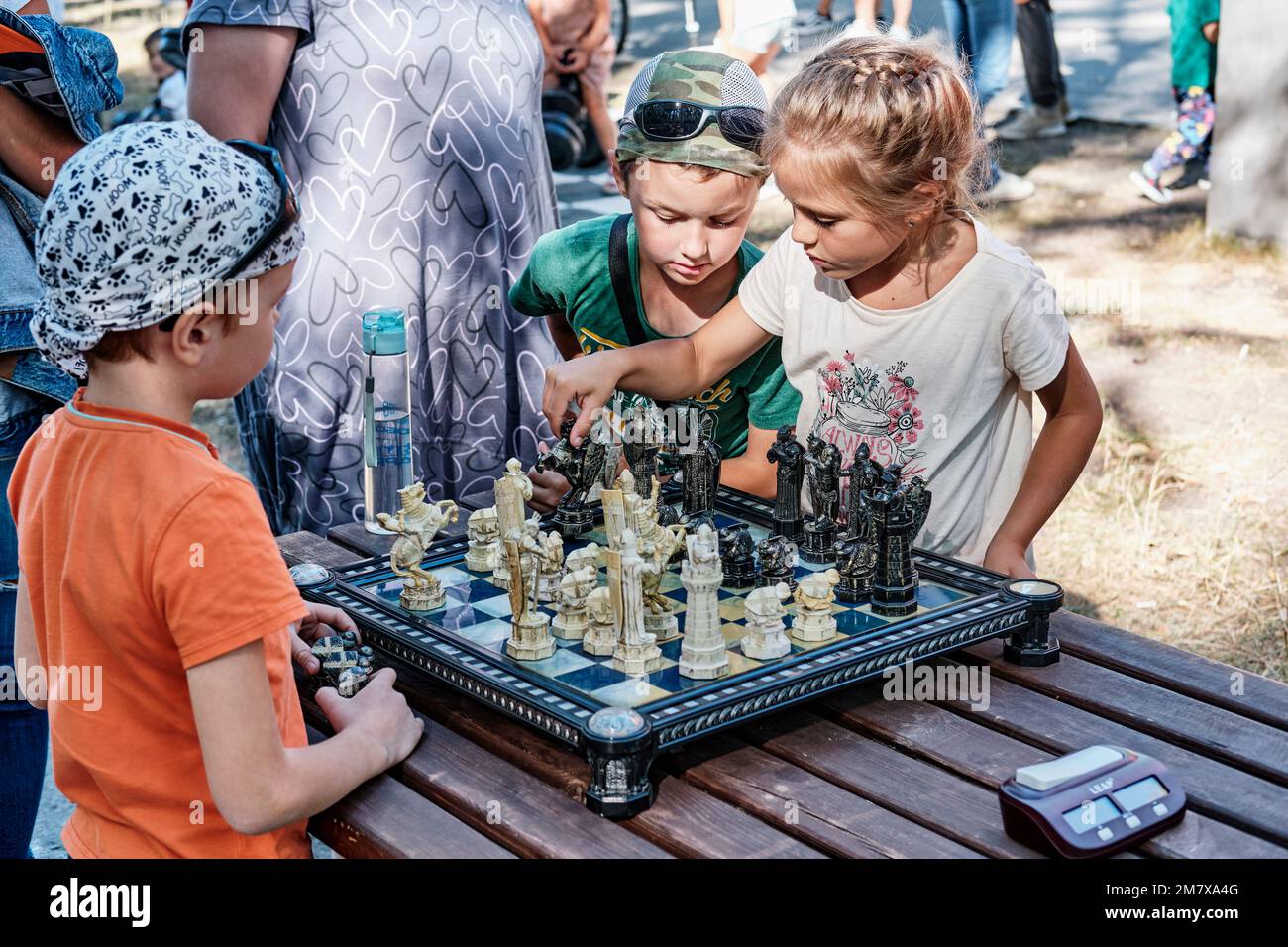 Yekaterinburg, Russia - August 28, 2022: Children playing chess with figures in form of characters from Harry Potter movie. Small girl making chess mo Stock Photo