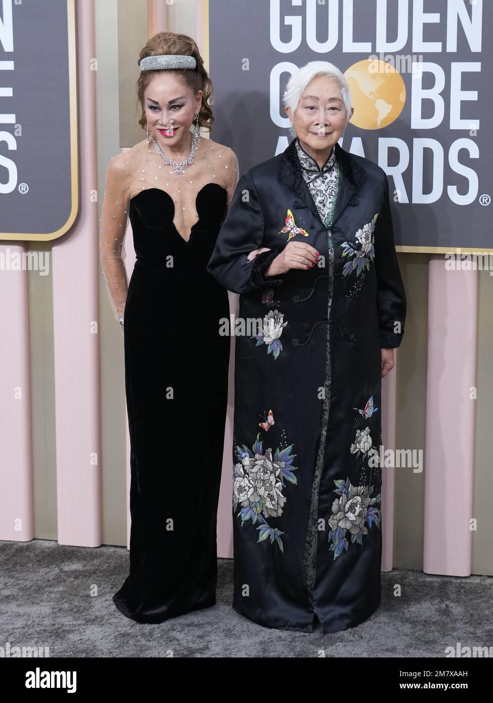 Lisa Lew (R) and guest arrive at the 80th Annual Golden Globe Awards