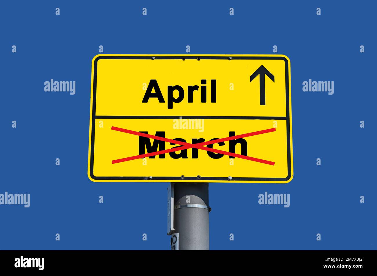 Yellow sign with black lettering. Below the word March crossed out in ...