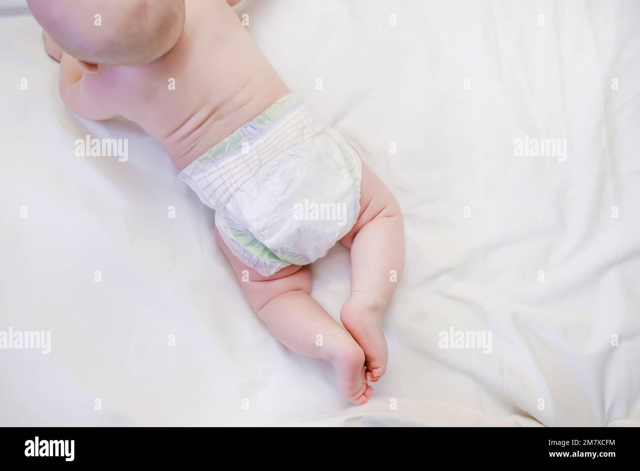 Top view of the child in diapers. Caring for a child who does not know