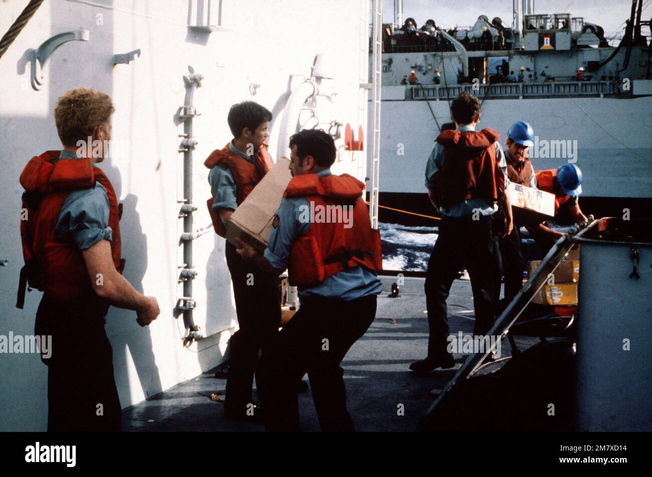 Canadian sailors aboard the HMCS IROQUOIS (DDG-280) transfer crates ...