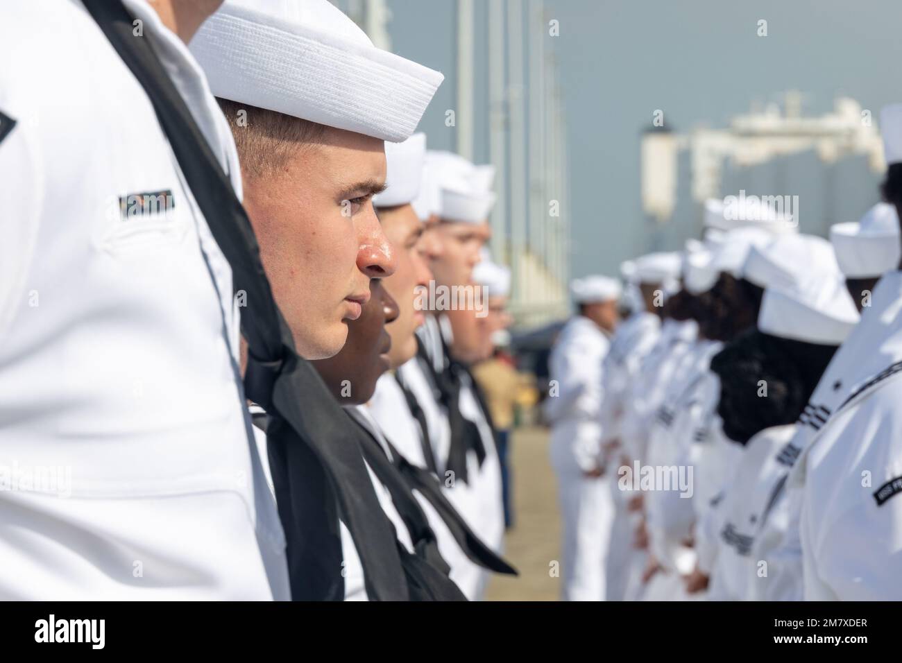 U.S. Sailors assigned to the USS Frank E. Petersen Jr. (DDG 121) stand ...