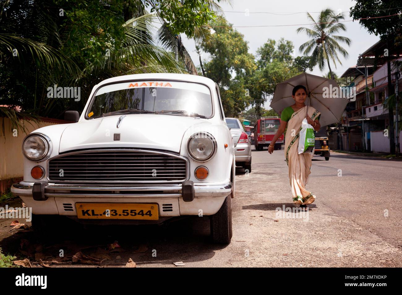 Cochin, India-September 5, 2012: Three things are very typical in India as warm, sharis and the Hindustan Ambassador car. A woman clothed with the sha Stock Photo