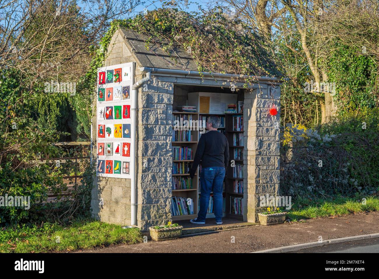 Community library in a disused bus shelter, Gloucestershire. Stock Photo