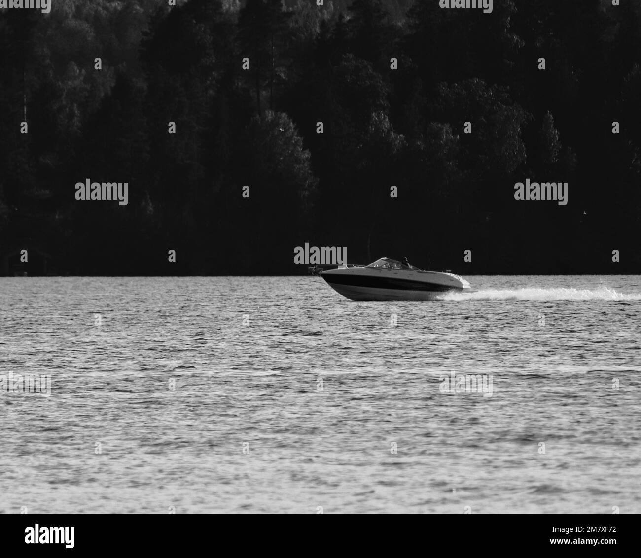 A beautiful grayscale view of a boat floating on a lake Stock Photo Alamy