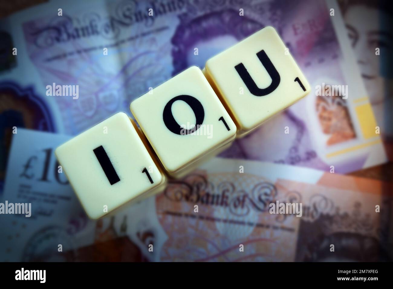 I Owe You, IOU, letters above sterling Bank Of England pound notes Stock Photo
