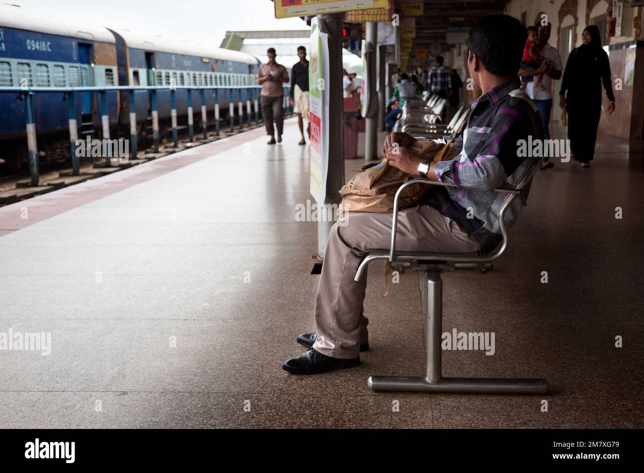 Mangalore, India-September 03, 2012. Several travelers on the platform waiting for the train that will take them to their destination Stock Photo