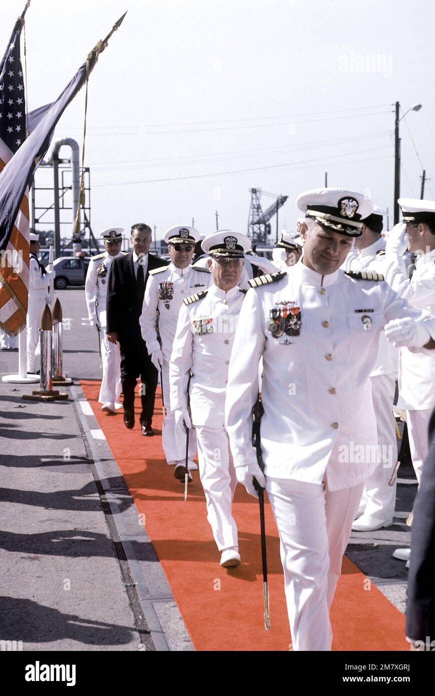 Two Navy captains salute as they come aboard the nuclearpowered attack