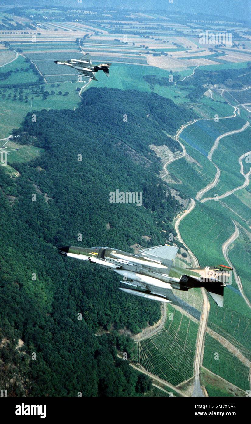 A left side view of two F-4 Phantom II aircraft from the 563rd Tactical Fighter Squadron, George Air Force Base, California, in flight during Exercise Reforger '81. Subject Operation/Series: REFORGER '81 Country: Deutschland / Germany (DEU) Stock Photo