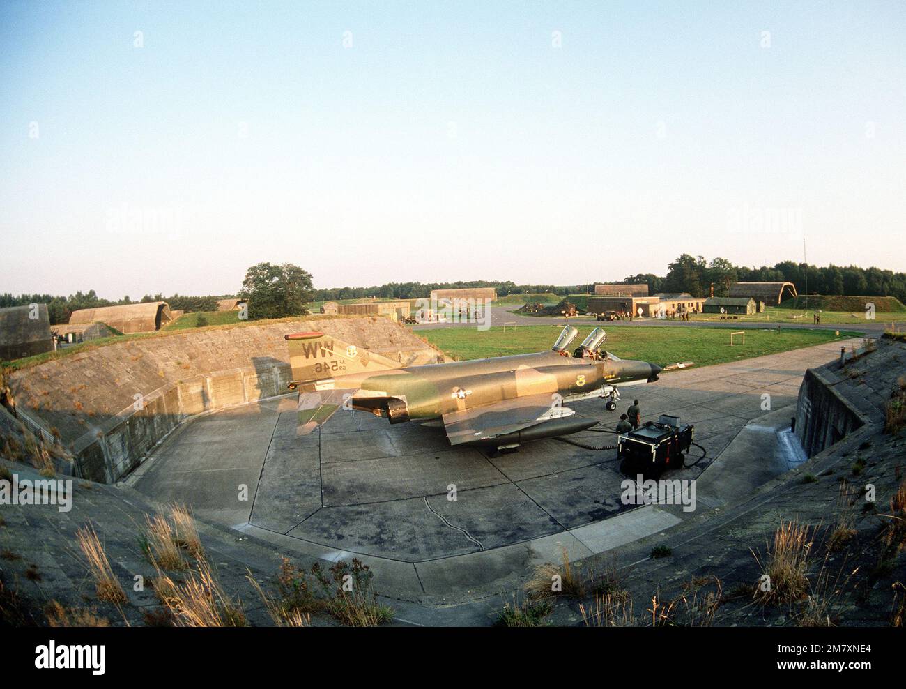 A left side view of an F-4 Phantom II aircraft from the 563rd Tactical Fighter Squadron, George Air Force Base, California, being prepared for flight by ground crewmen during Exercise Reforger '81. Subject Operation/Series: REFORGER '81 Base: Raf Wildenrath Country: Federal Republic Of Germany (FRG) Stock Photo