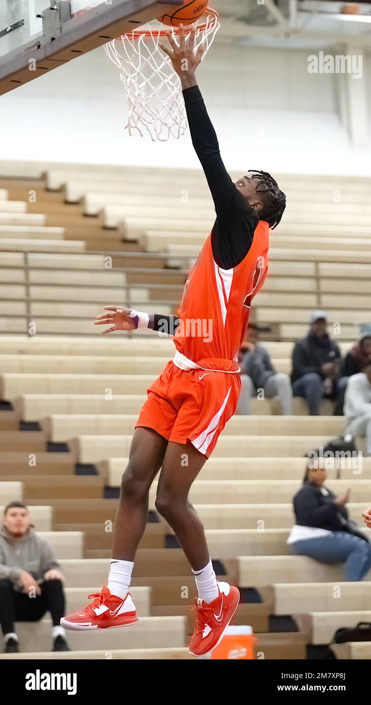 A vertical shot of a young male player dunking at a fall Merrillville