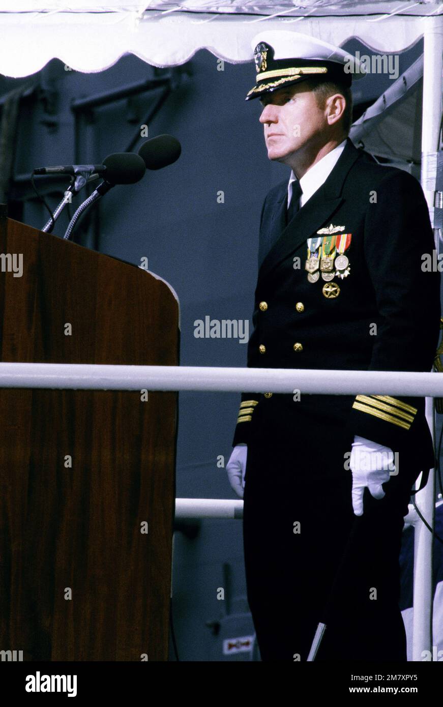 CDR Floyston A. Weeks, commander of the guided missile frigate USS AUBREY FITCH (FFG-34), stands before the speaker's podium during the ship's commissioning ceremony. Base: Bath State: Maine (ME) Country: United States Of America (USA) Stock Photo