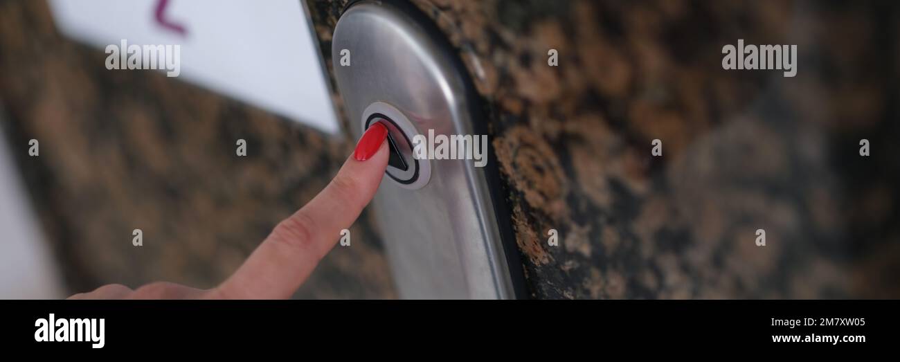 Female finger with presses elevator button closeup Stock Photo