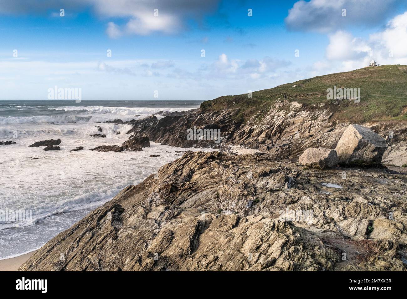 Incoming tide at the rocky rugged Little Fistral on the coast of Newquay in Cornwall in England in the UK. Stock Photo