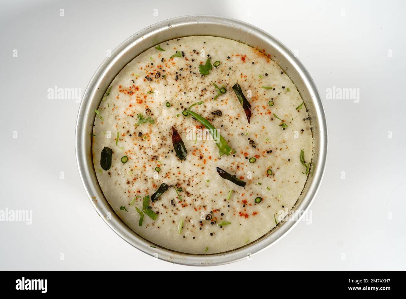 Spongy white dhokla popular Gujarati steamed breakfast with rice or rava served with green