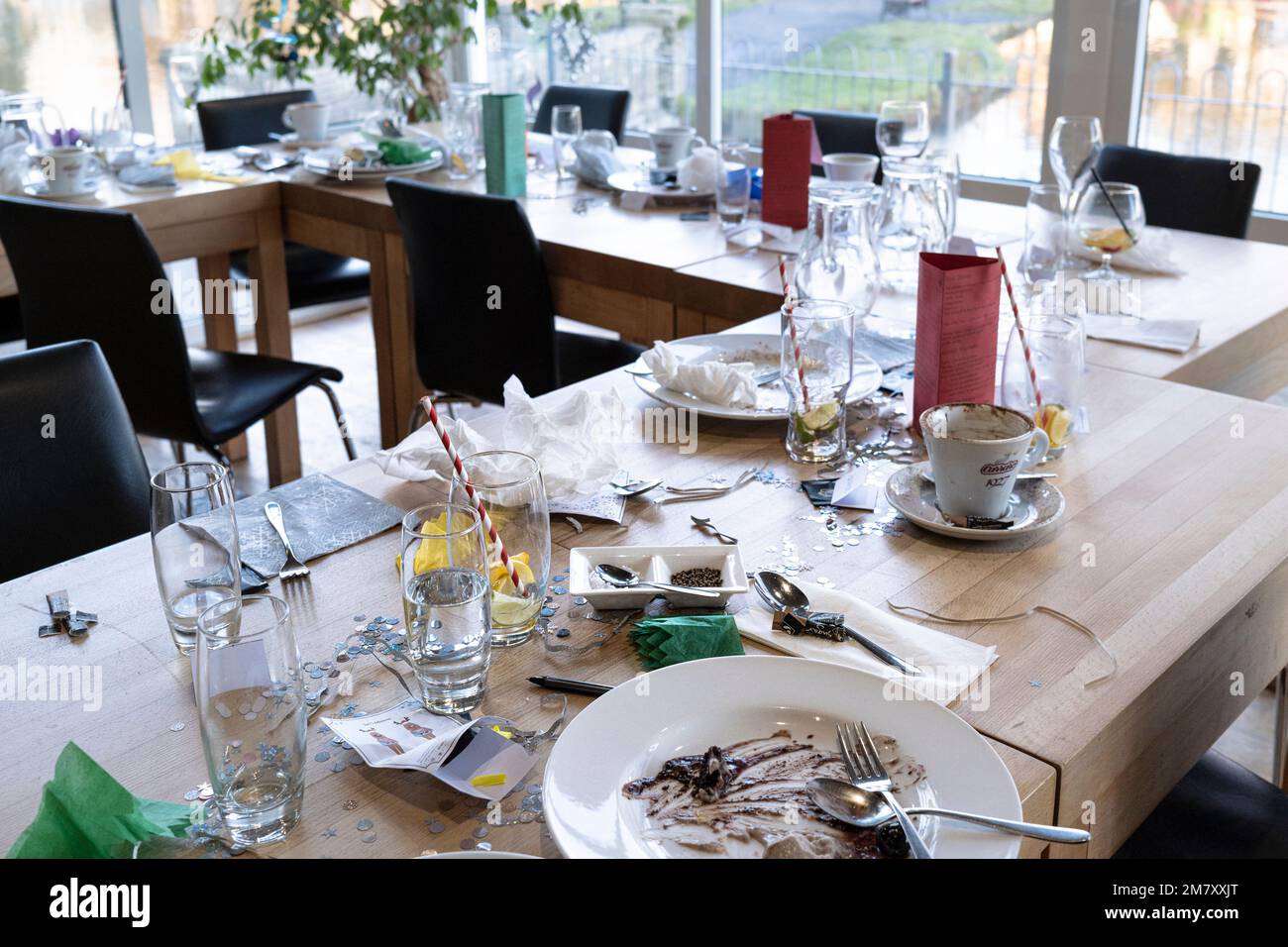 The remains of a Christmas meal on a table in a restaurant. Stock Photo