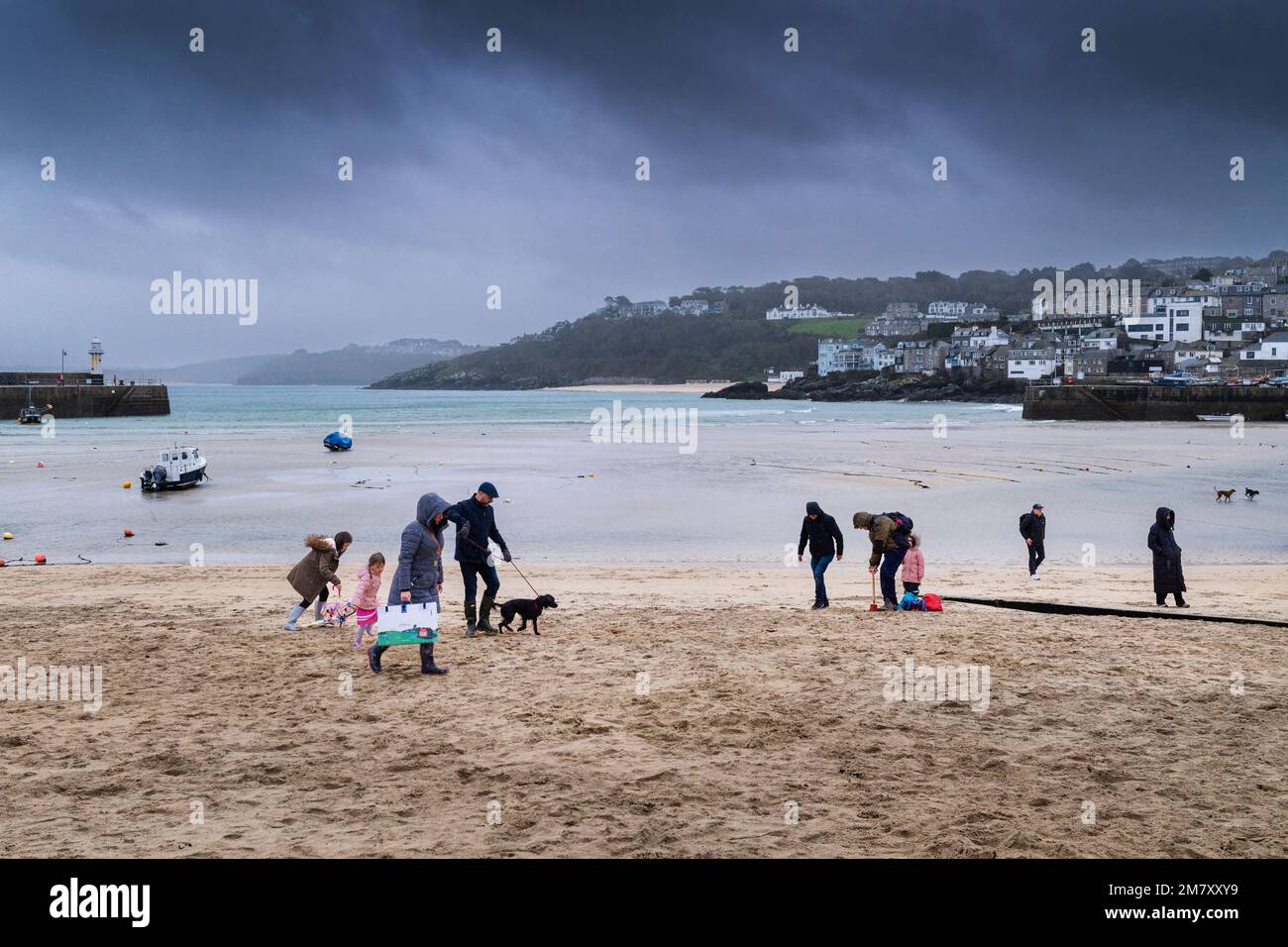 Holidaymakers on St Ives Beach during the closed season in Cornwall in