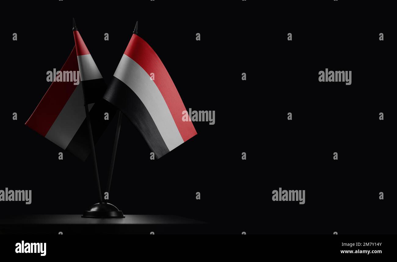 Small national flags of the Yemen on a black background. Stock Photo