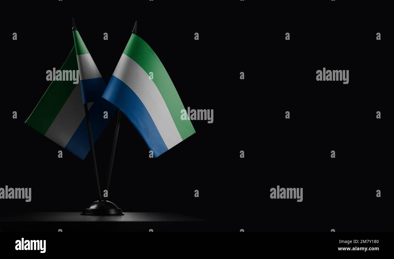 Small national flags of the Sierra Leone on a black background. Stock Photo