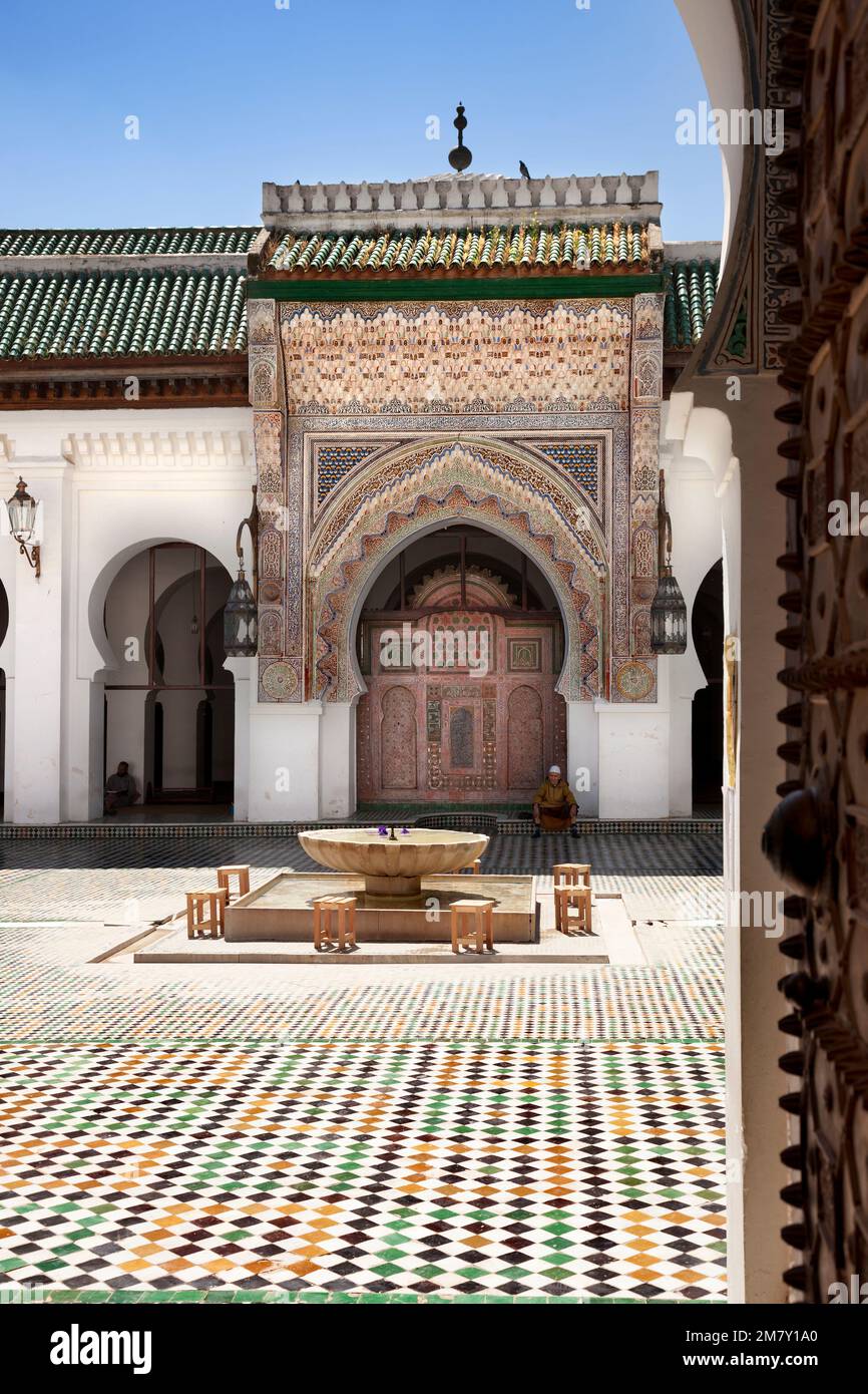 Fez, Morocco-April 23, 2014: People sitting in a Mosqe wating the prayer time during a nice spring morning on the terrace of a bar in the Medina of Fe Stock Photo