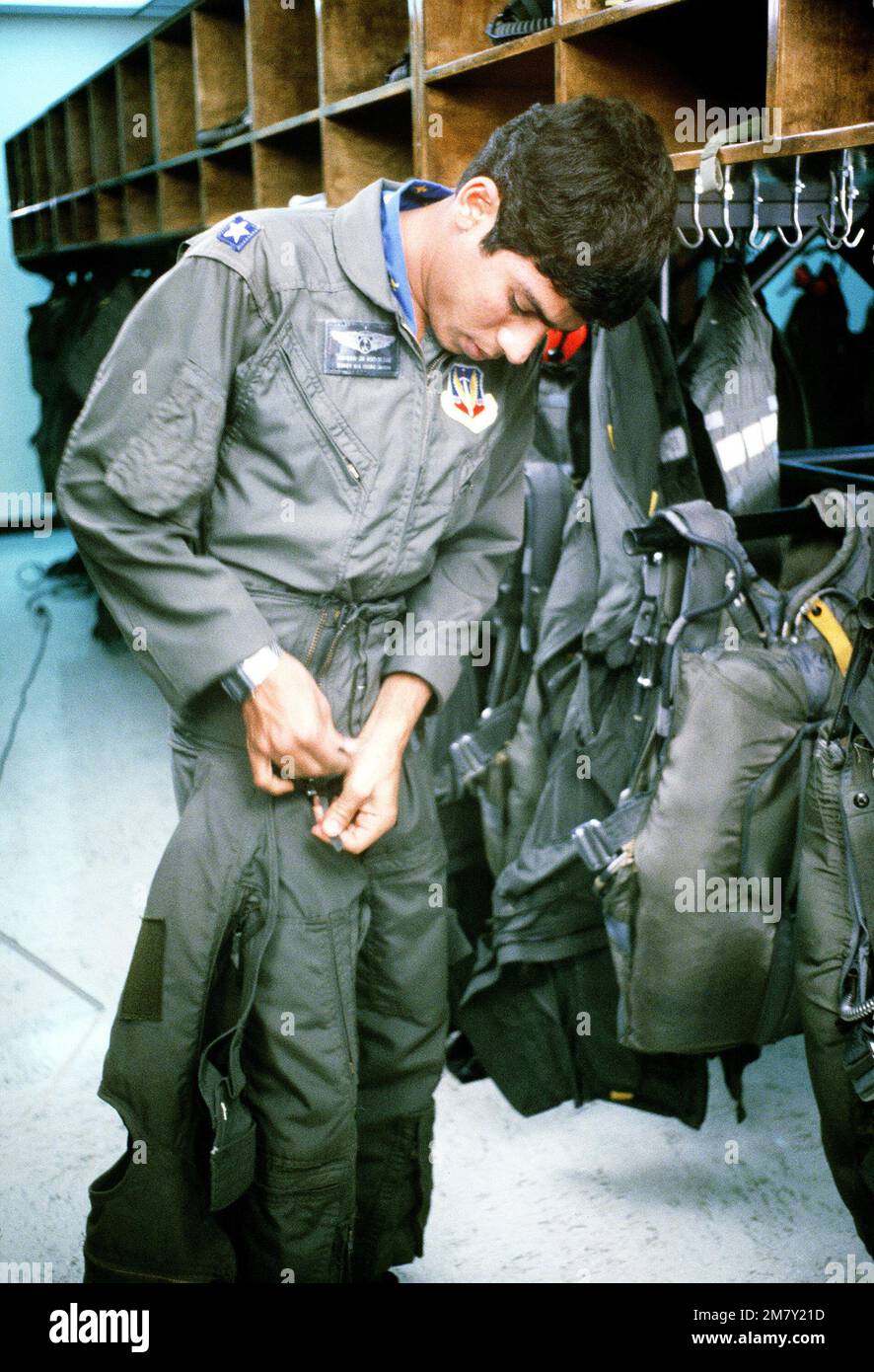 2LT Sulieman Al-Rabiah takes his flight gear off the rack and suits up prior to flying a training mission. Base: Williams Air Force Base State: Arizona (AZ) Country: United States Of America (USA) Stock Photo