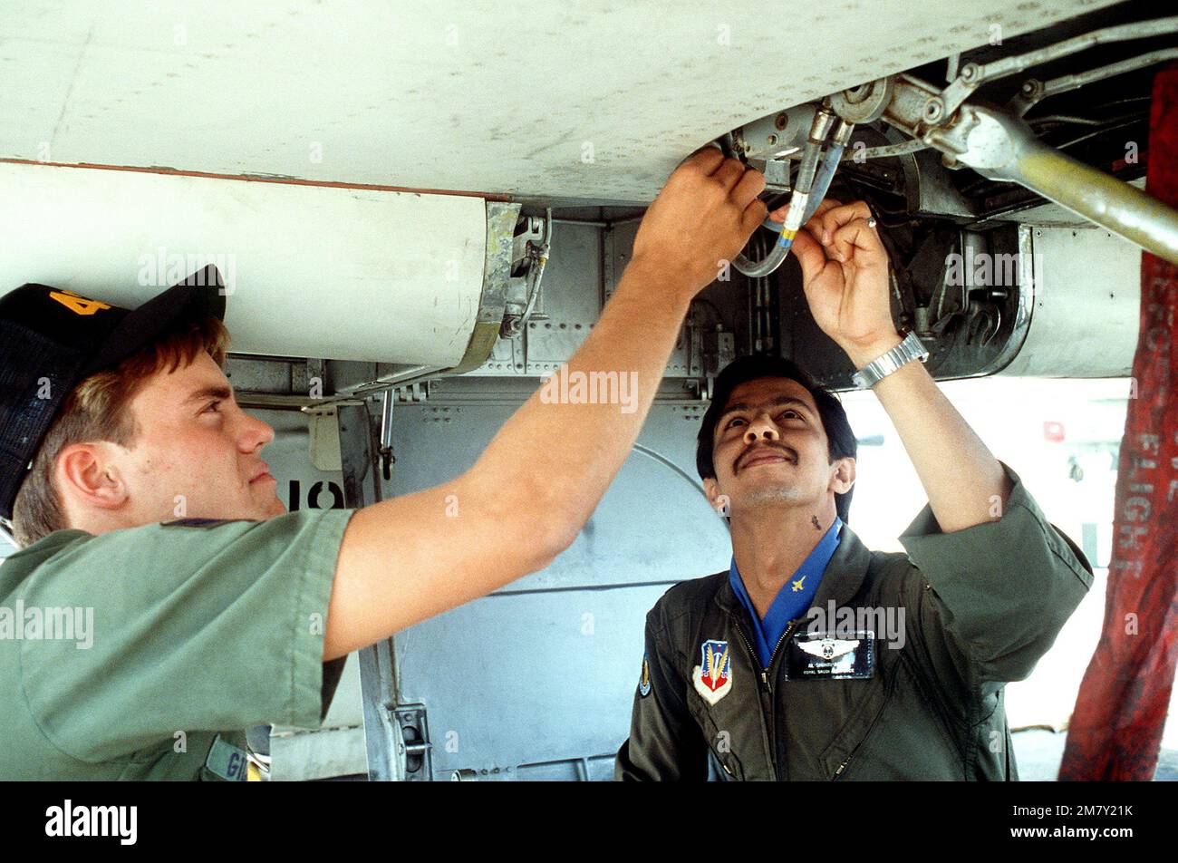 SRA Greg Pierce of the 425th Fox Flight Maintenance Crew assists Saudia Arabian 2LT Sulieman Al-Shihri with a pre-flight check. Base: Williams Air Force Base State: Arizona (AZ) Country: United States Of America (USA) Stock Photo