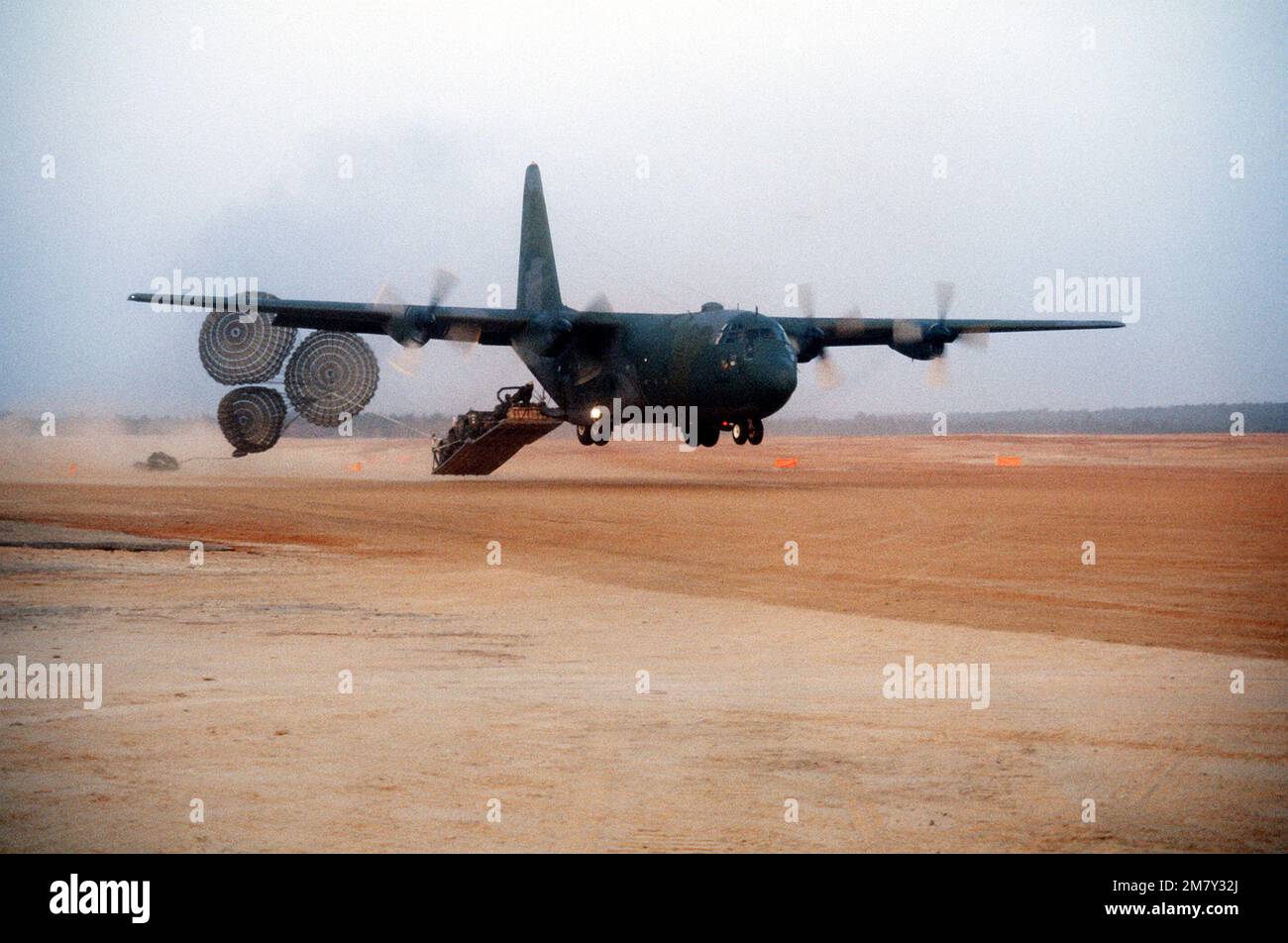 A right front view of a C130 Hercules aircraft airdropping cargo using