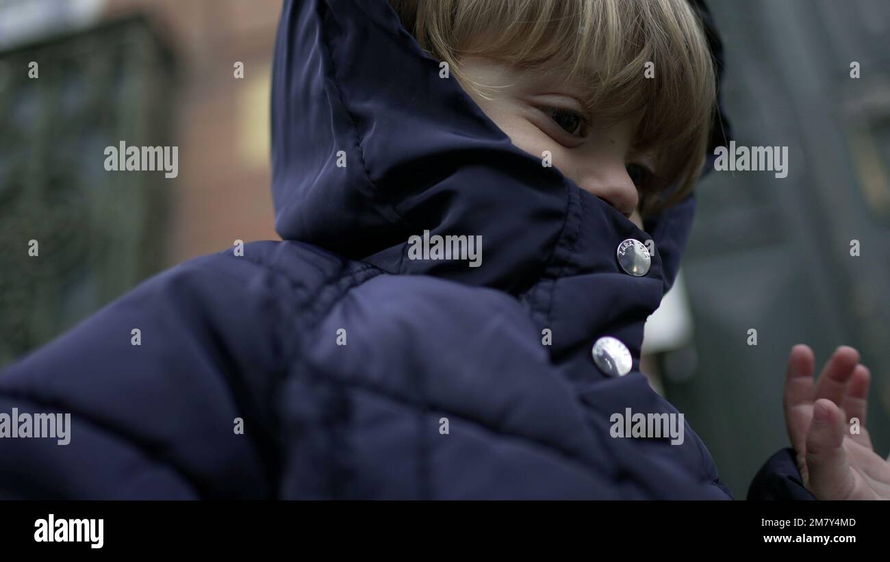 Little baby boy wearing warm winter clothing during winter season ...