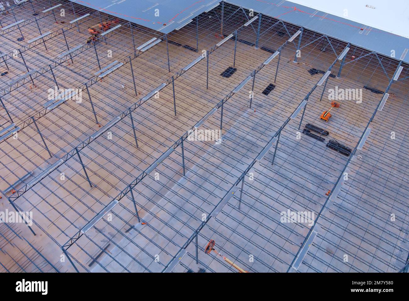 An under construction warehouse roof truss is made metal frame steel framework located on building site Stock Photo