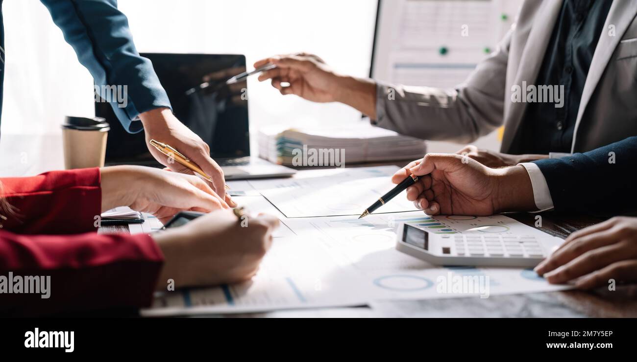 Business people analyzing investment graph meeting brainstorming and discussing plan in meeting room, investment concept Stock Photo