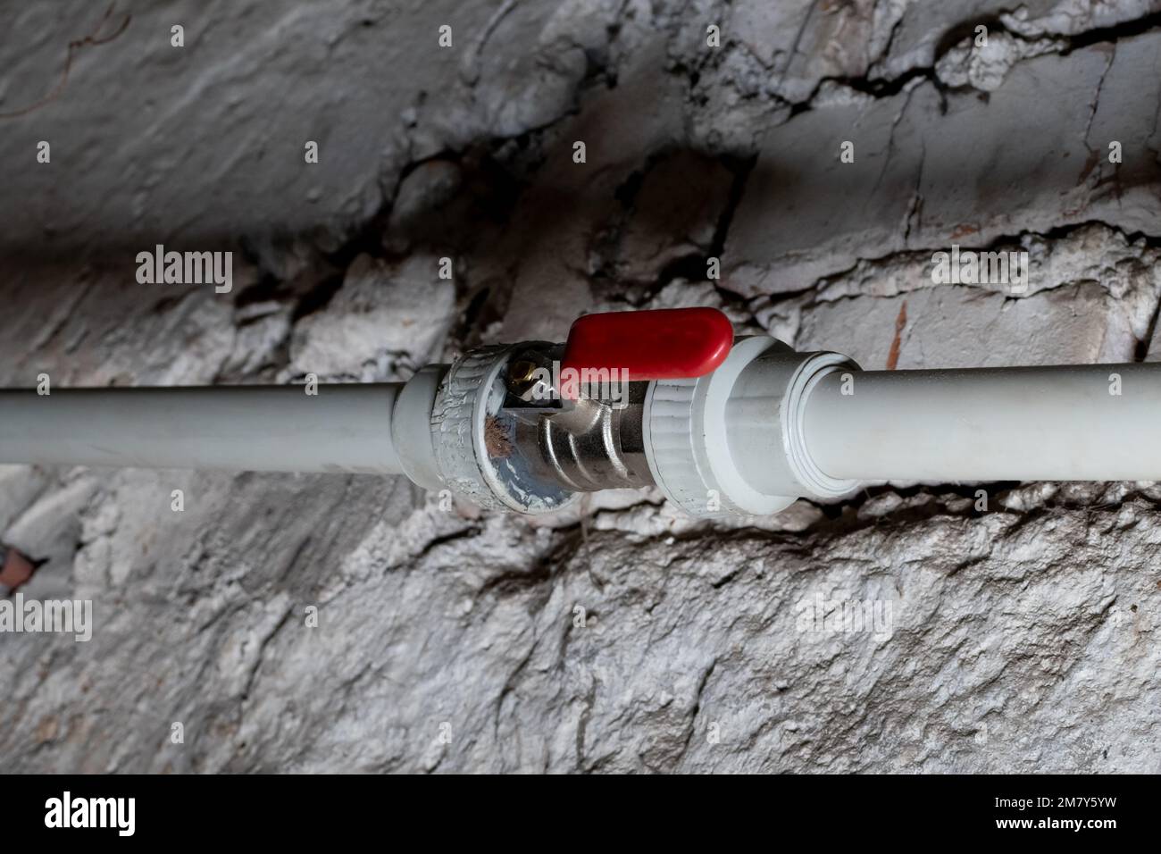 Faucet of water plastic pipe in open position on blurred background of