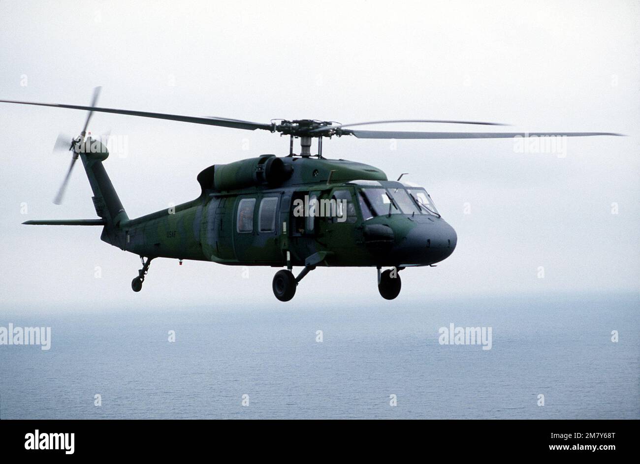 Right side air-to-air view of a UH-60A Black Hawk helicopter en route ...