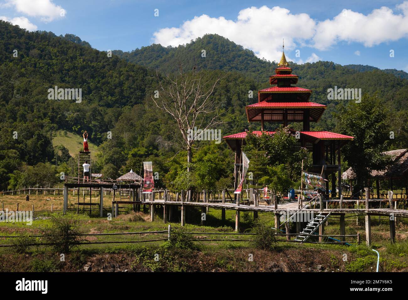 Pai, Thailand. November 21, 2022. Kho Ku So Bamboo Bridge over the rice fields in Pai, Norhern Thailand. Tourists posing and taking a photograph. Stock Photo