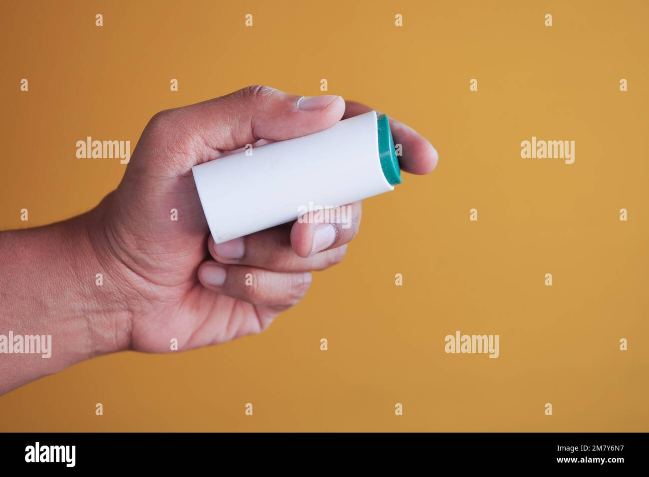 young man putting artificial sweetener in tea, Stock Photo