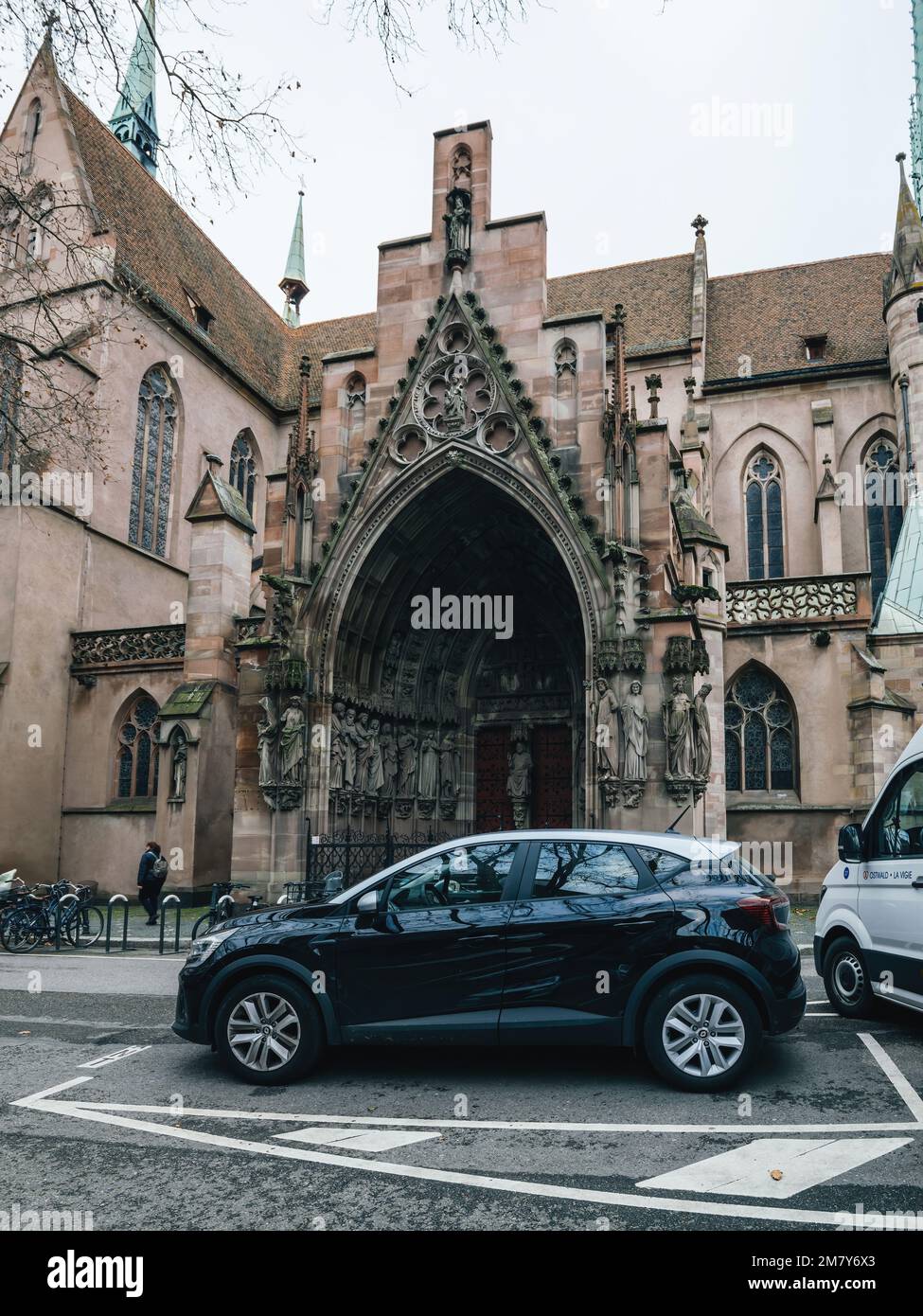 Strasbourg, France - Jan 5 2023: Renault car parked in front of Eglise Saint-Pierre-le-Jeune Protestant church in central Strasbourg Stock Photo