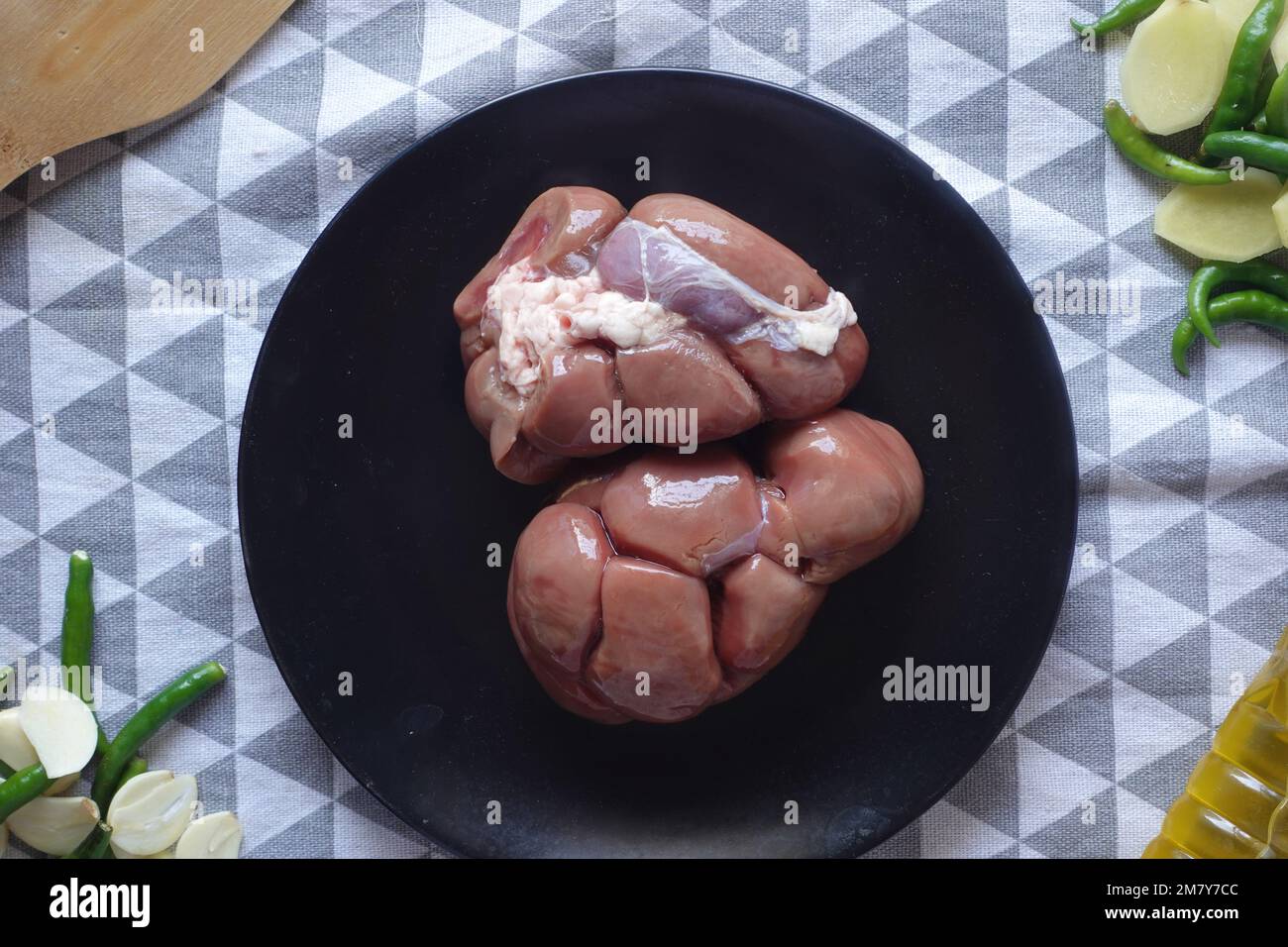 Raw fresh lamb kidneys on a chopping board  Stock Photo