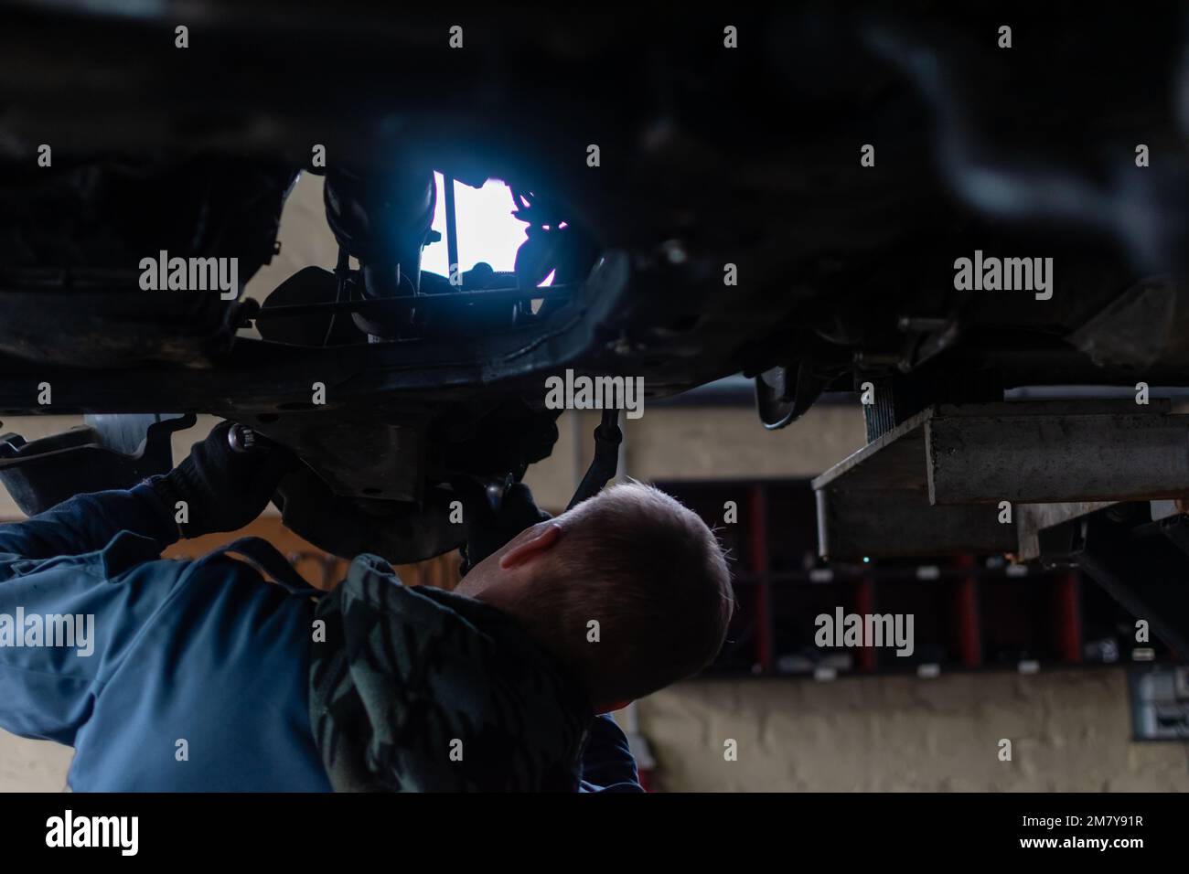 Repair of undercarriage of front suspension of vehicle in garage of car