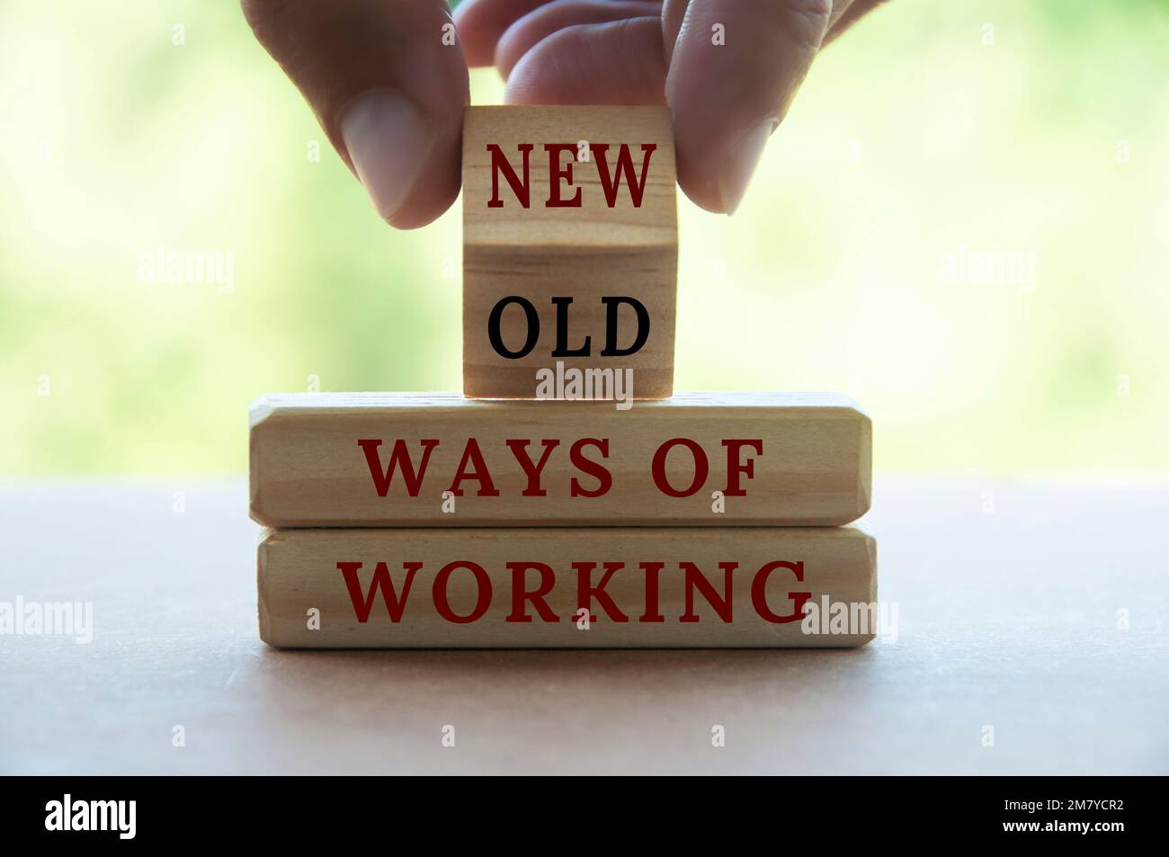 Hand turning wooden cube text from OLD to NEW ways of working. New normal and business concept Stock Photo